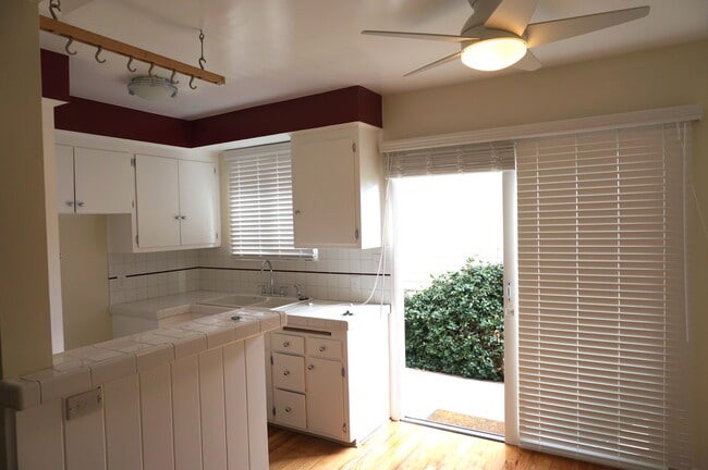 Newly tiled kitchen with stove and large sliding glass doors - 14333 Albers St Unit 3