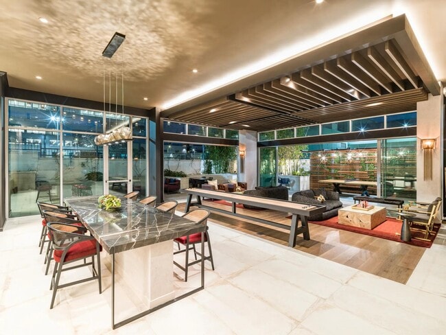 Sophisticated lounge spaces at Modera Argyle feature stylish seating, shuffleboard, and inviting areas to relax, entertain, or connect with neighbors. - Modera Argyle