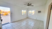 Living room with ceiling fan and natural light - 5527 Baileya Ave Unit A
