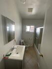 Bathroom with large new vanity and porcelain tile and bathtub - all new fixtures - 10513 Crenshaw Blvd Unit 10513 Crenshaw Blvd #1