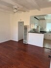 kitchen opens up to living room with breakfast bar. - 124 Quincy Ave Unit #4