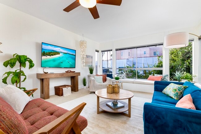 Bright open living area with ocean view, 65” 4K Smart TV, and designer furnishings - 2221 Ocean Ave Unit 202