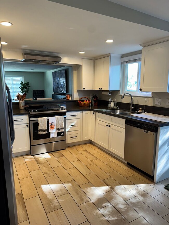 Photo - Charming 2-Bedroom, 1.5-Bath Apartment with Private Yard and 1 Car Garage Unit A