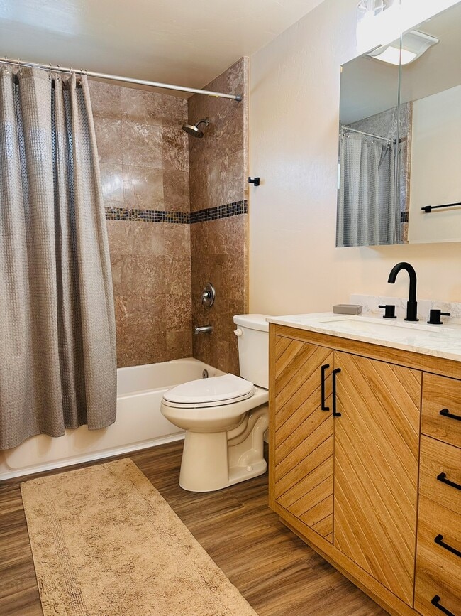 Bathroom 1 with tub and shower. - 358 22nd St Unit Two