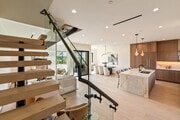 Floating stairs with glass railing leading to the bedroom level - 836 Waterloo St House