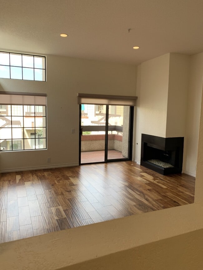 living room, balcony, fireplace facing north - 2601 S Broadmoor Dr Unit 2601 So Broadmoor Drive