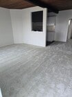 Living room, view from front door, all new paint, carpet - 1616 Esplanade Apartments