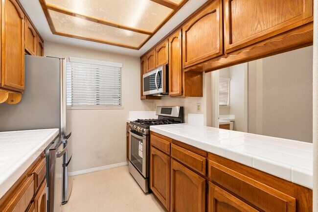 Photo - 2 Bedroom 1.5 Bath Townhome with  pvt patio (AC/Pool/Gated Parking/EV Chargers) Unit 7012 Casa Lane #14