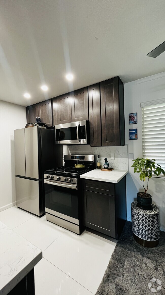 Building Photo - 6600 Warner Ave Unit Modern Condo