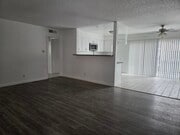 Living room with luxury vinyl plank flooring - 3455 Elm Ave Unit #215