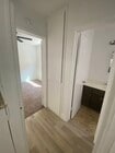 Hallway to bedroom and bathroom. Storage cabinets. - Sunshine Apartments
