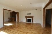 Bright open concept living space with oak wood floors and a working fire place. - 4831 Canoga Ave