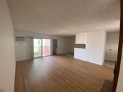 Living room with view to balcony - 3717 Cardiff Ave Apartments