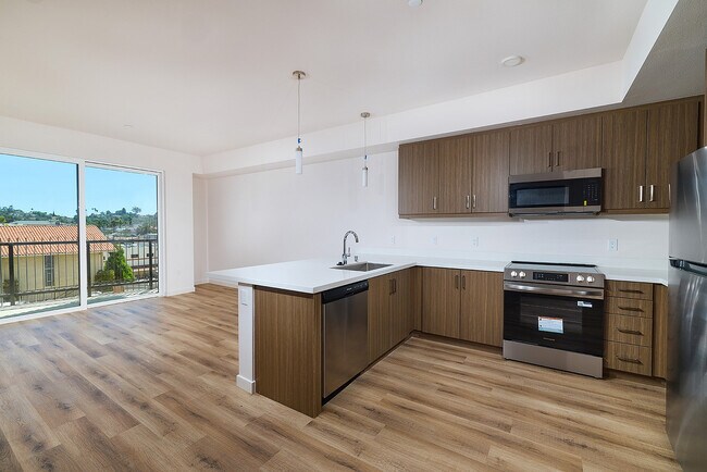 Host friends easily around premium quartz countertops and a spacious kitchen breakfast bar. - textur Apartments