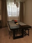 Dining Room with floor to ceiling curtains. Table and chairs are not included in lease. - 10315 Missouri Ave Townhome