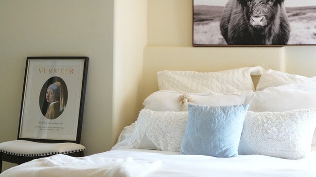 The bedroom with the view has a window that allows natural light to come in and illuminate the room. - 4160 Barrett Rd Apartments Unit Charming Abode