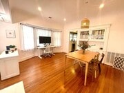 Dining area leading into the kitchen, featuring original built-ins alongside modern updates. - 6000 Carlton Way