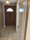 Front entryway with tiled floor and coat closet. - 14911 Fonthill Ave