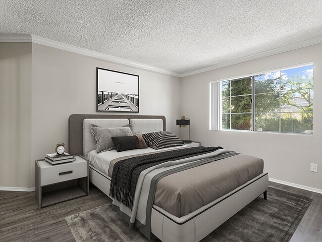 Carpeted bedroom with large window for natural light. - Tilden Oaks