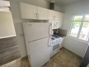 kitchen with stove, microwave and refrigerator - 6230 Milton Ave Apartments Unit A