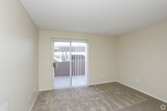 Downstairs bedroom sliding glass door to balcony - Benchmark Apartments