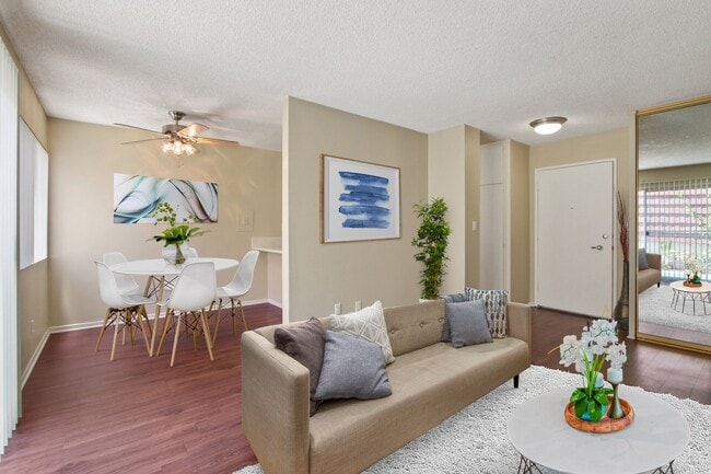 Living room and dining area with wood-style floors throughout - Seville Townhouse
