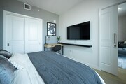 Bedroom has a TV and working desk - 400 S Broadway Condo Unit 2604