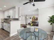 Dining room view into living room and kitchen. - Hughes Regency Apartments