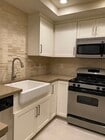Quartz countertops, natural stone backsplash and deep farm house sink - 19215 Shoreline Ln