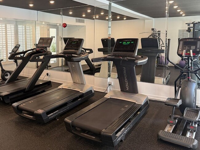 Fitness Center With Treadmills, Free Weights, and Bikes. - Clarington Court