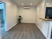 Brand new vinyl flooring throughout home. Living room houses the heater and AC - 9300 Benson Way Apartments Unit B
