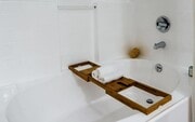 White Tile Bathroom with Oversized Tub and Relaxation Setup - Villas at the Gardens Apartments