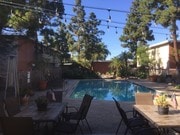 Beautiful pool with stringed lights at patio - Beachwood Village Apartments