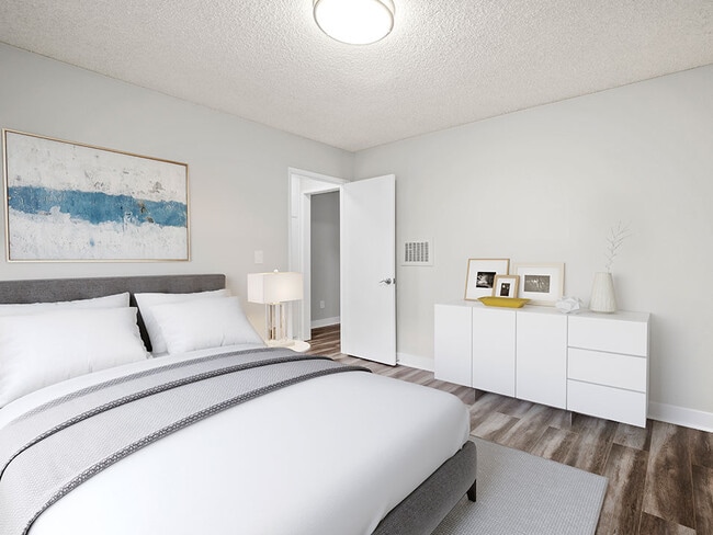 Hardwood floored bedroom with private closets and ceiling-mounted light fixtures.. - 10620 NoHo