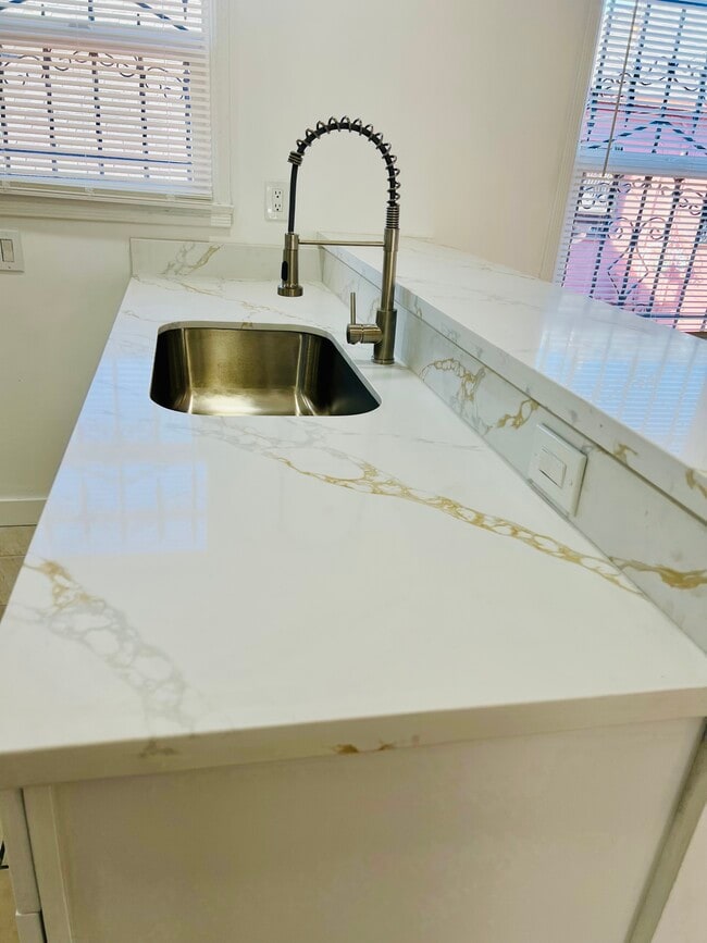 Beautifully remodeled kitchen with new appliances, microwave, marble countertops, pull-down sprayer - 3551 W Manchester Blvd