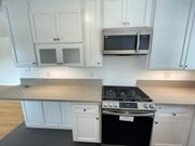 kitchen. samsung gas range and microwave. under counter light - 7855 W Manchester Ave Unit 3