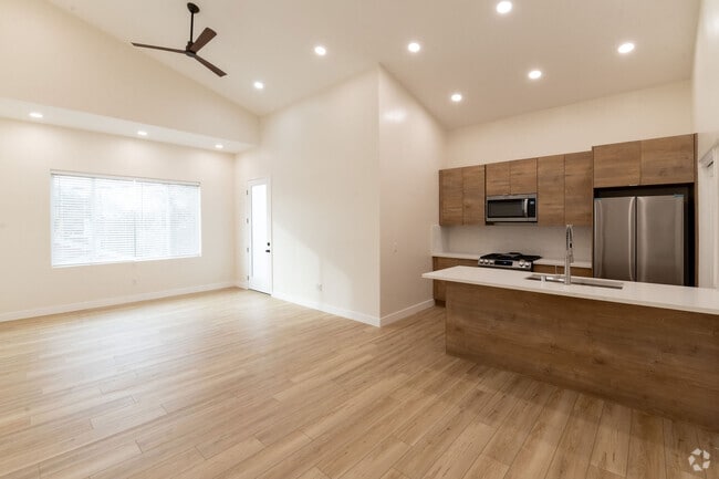 Large living space with 14 ft ceilings.Door leads to roof top deck. - 4774 Bancroft St Unit A Rental