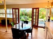 The glass doors from the dining room open to the pleasant sounds of the cascades in the backyard. - 11449 Woodbine St