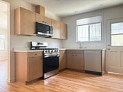 Kitchen with brand new stainless steel appliances, quartz countertops, and maple cabinets - 1041 Wilcox Ave Unit 1041