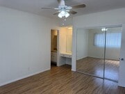 Apt #5: Bedroom #1 with ensuite bathroom with shower, mirrored closets, and dressing area - 321 E Dryden St