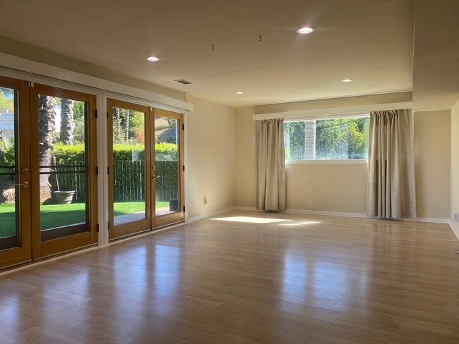 Large open living room French doors natural light - 4421 Grimes Pl