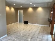 Spacious original living room with tiled floor, recessed lighting, and refurbished original 1952 Hol - 14911 Fonthill Ave
