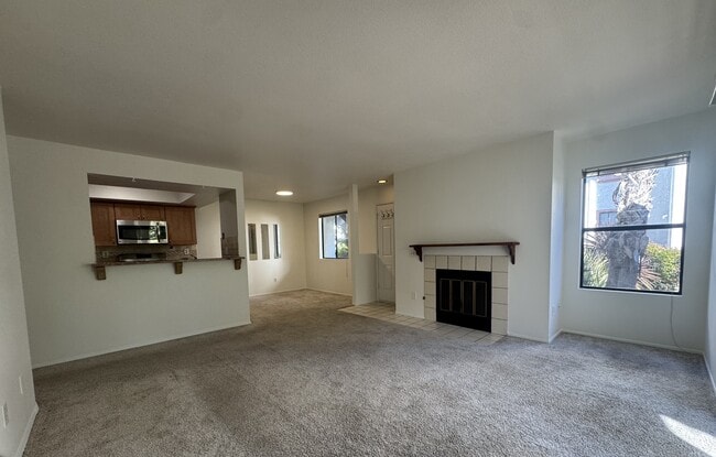 living room, dining room, fireplace, and kitchen - 9408 Twin Trails Dr Unit 106