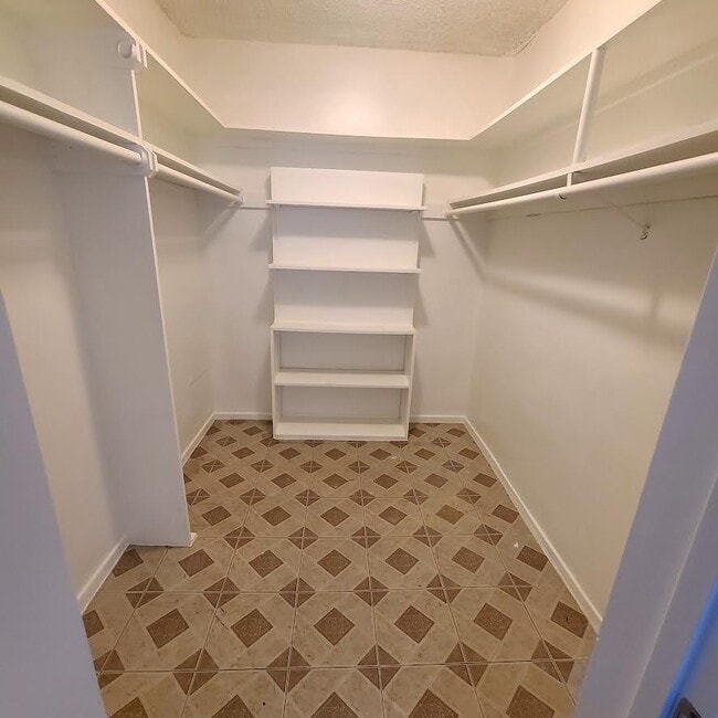 master bedroom walk in closet - 5555 W 8th St Apartments
