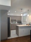 Modern kitchen with Euro cabinets, quartz countertops, and new stainless steel appliances - 5652 Yolanda Ave Unit #9