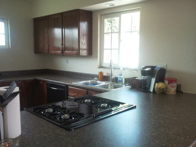 Gorgeous kitchen with slide-in stove, stainless steel sink, faucet with pull-down sprayer, garbage disposal, and dishwasher! - 400 East Airport Avenue