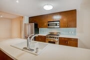 Kitchens are complete with Caesarstone countertops and decorative backsplash - 5550 Wilshire at Miracle Mile by Windsor Apartments