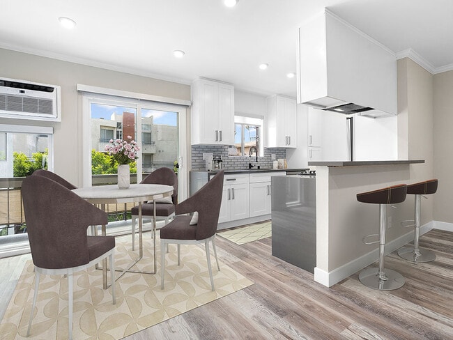 Hardwood floored dining room near bar seating in kitchen. - 1249 South Bundy