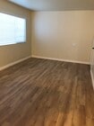 Large Living room with wood laminate flooring. - 9226 Palm St Unit B
