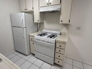 Kitchen stove and fridge - 3717 Cardiff Ave Apartments